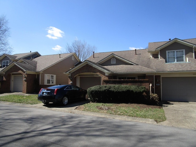 multi unit property featuring brick siding and driveway