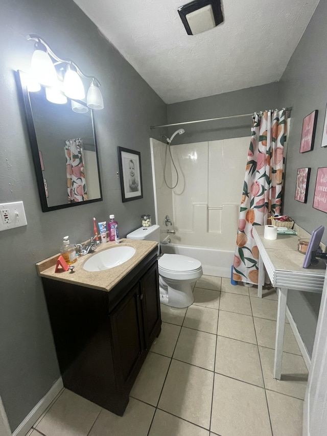 bathroom with toilet, vanity, shower / tub combo, tile patterned floors, and a textured ceiling