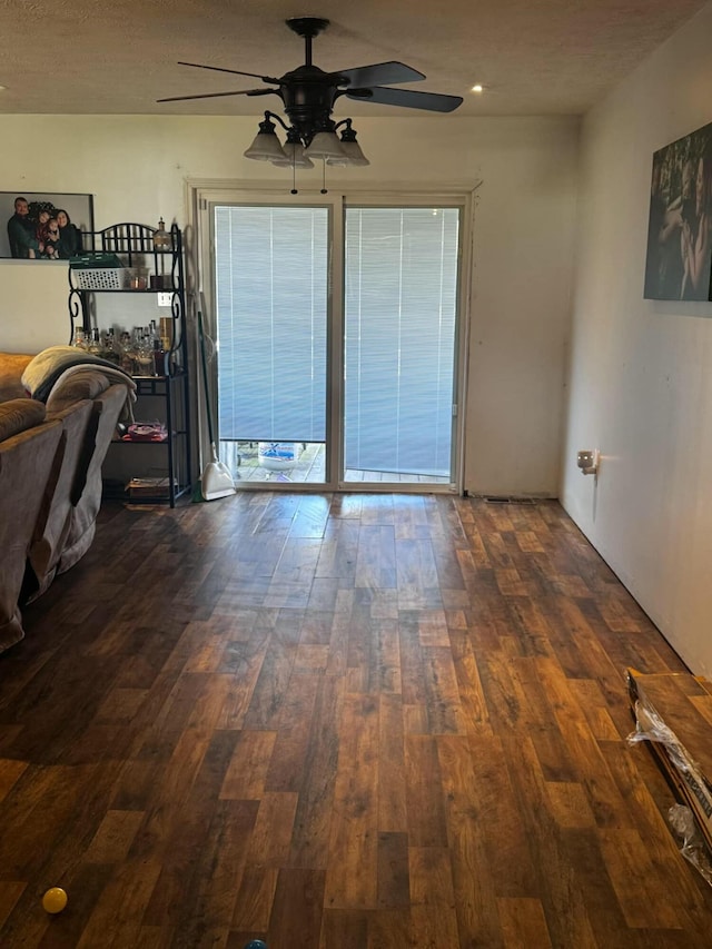 empty room featuring dark wood finished floors and a ceiling fan