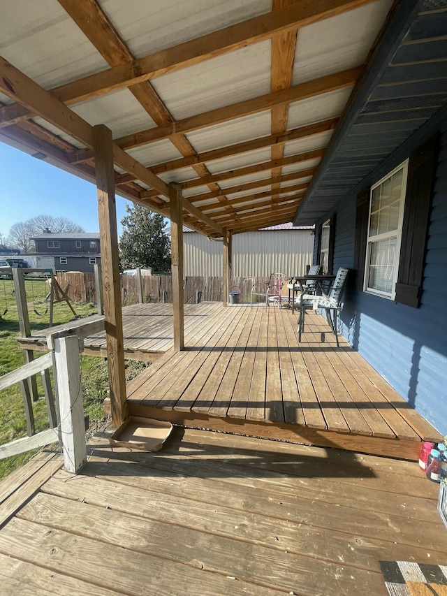 wooden terrace featuring fence