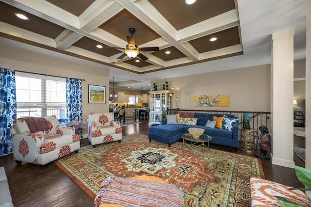 living area featuring beam ceiling, coffered ceiling, and wood finished floors