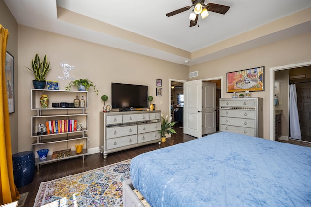 bedroom featuring ceiling fan, wood finished floors, visible vents, and baseboards