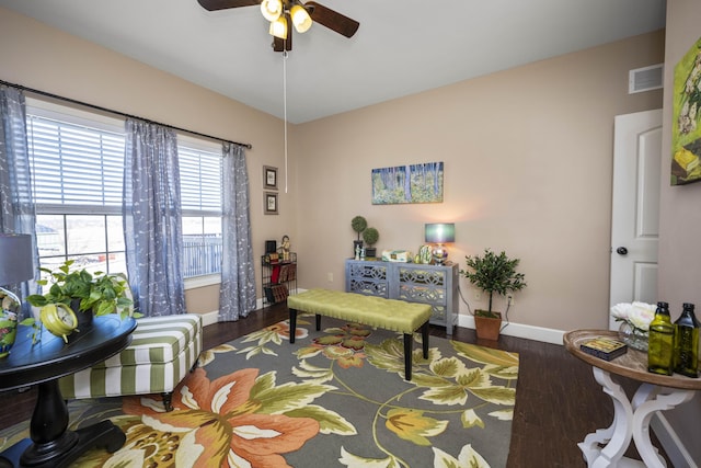 living area featuring ceiling fan, wood finished floors, visible vents, and baseboards