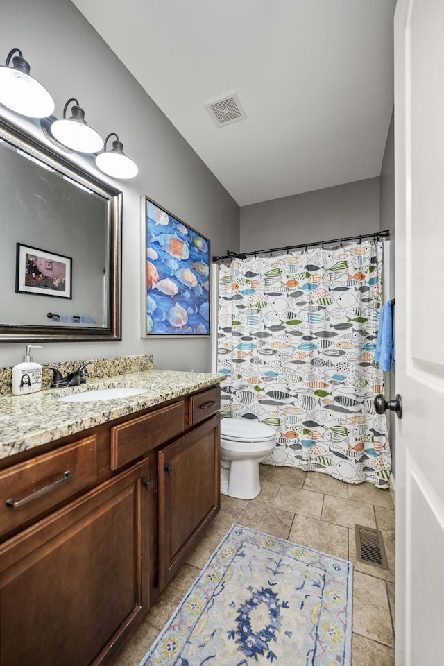 bathroom featuring visible vents, toilet, vanity, and a shower with curtain