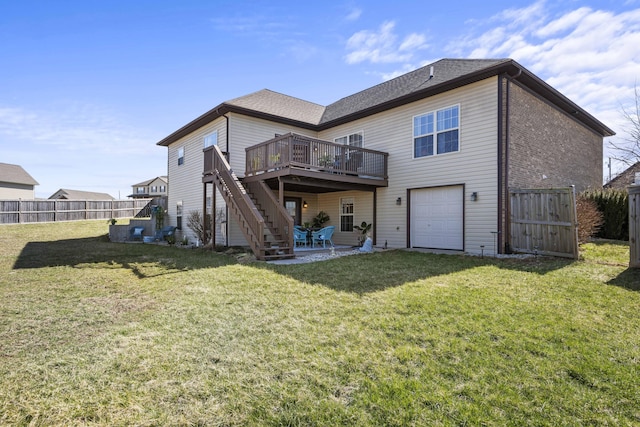 back of property with stairway, fence, an attached garage, a patio area, and a lawn