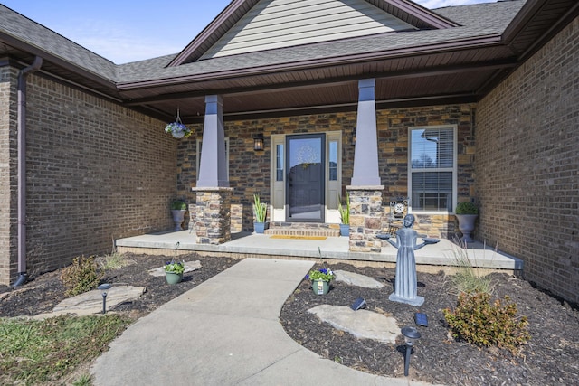 entrance to property featuring brick siding, a porch, and a shingled roof