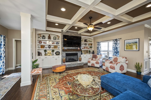 living room with baseboards, coffered ceiling, a stone fireplace, and dark wood finished floors