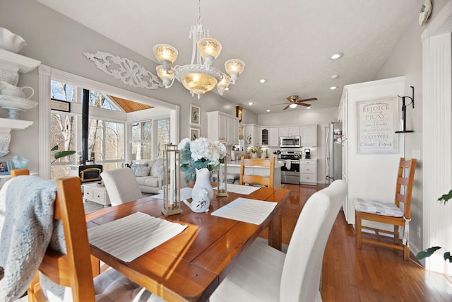 dining space with recessed lighting, baseboards, ceiling fan with notable chandelier, and hardwood / wood-style flooring