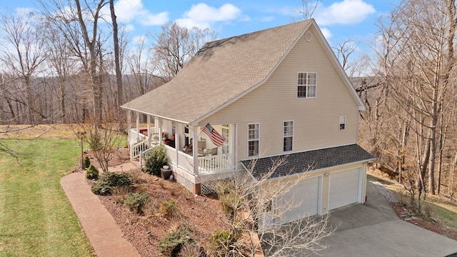 view of home's exterior featuring an attached garage, concrete driveway, a yard, and a shingled roof