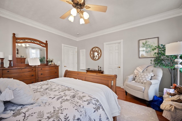 bedroom with crown molding, ceiling fan, and wood finished floors