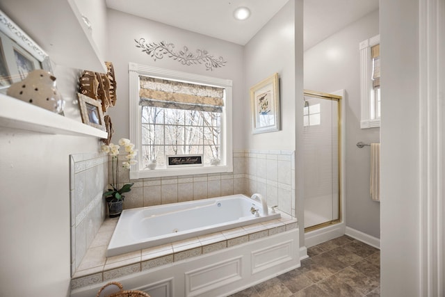 full bath with a stall shower and a whirlpool tub