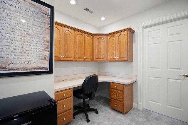 office space featuring recessed lighting, light colored carpet, visible vents, and built in desk