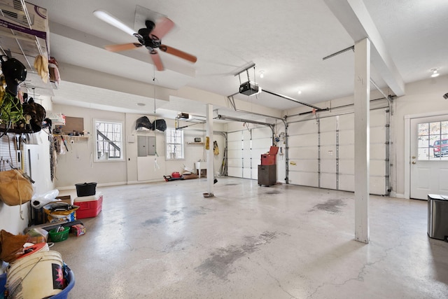 garage featuring electric panel and a garage door opener