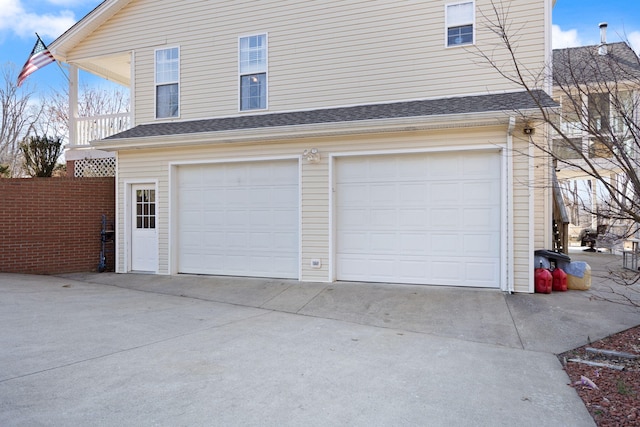 garage featuring concrete driveway