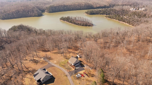 aerial view featuring a wooded view and a water view