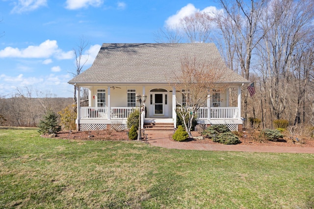 view of front of house featuring a front yard, covered porch, and roof with shingles