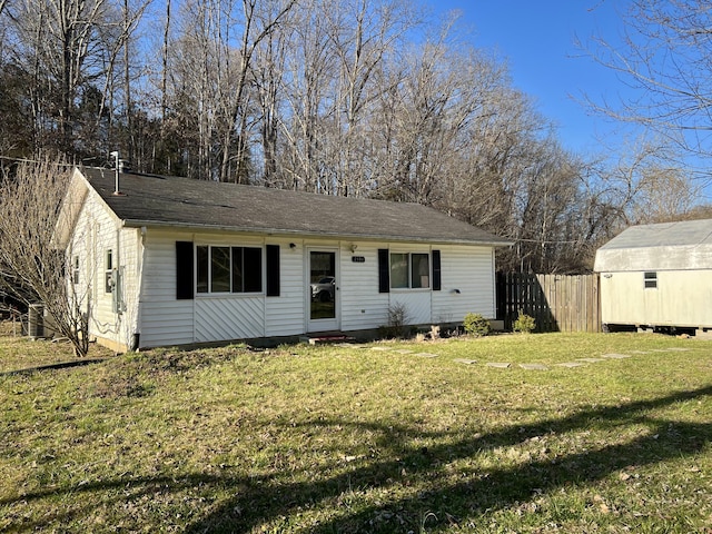 view of front of property with a front yard and fence