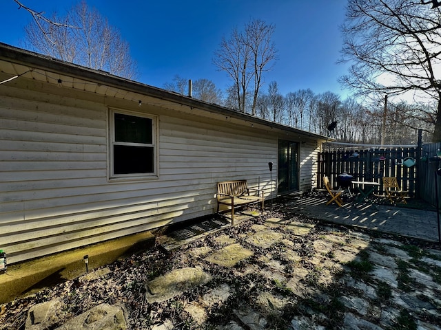 back of house with a patio and fence