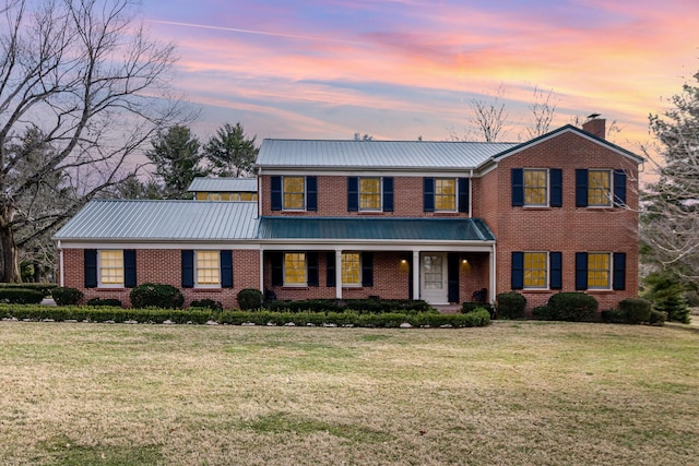 2136 Adena Ln, Lexington, KY 40516 - view of front of property with brick siding, a chimney, metal roof, and a front lawn