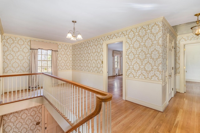 2136 Adena Ln, Lexington, KY 40516 - corridor featuring light wood-style floors, a wainscoted wall, a notable chandelier, and wallpapered walls