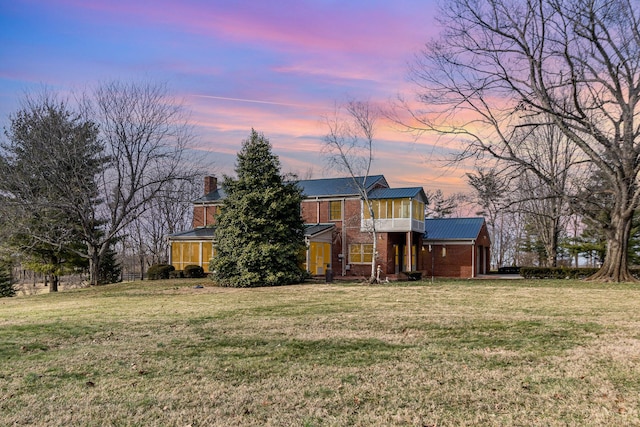 2136 Adena Ln, Lexington, KY 40516 - back of house featuring brick siding, a chimney, a balcony, and a lawn