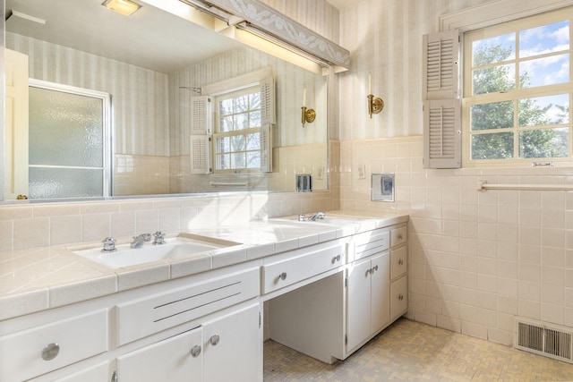 2136 Adena Ln, Lexington, KY 40516 - full bathroom with visible vents, wallpapered walls, double vanity, tile walls, and a sink