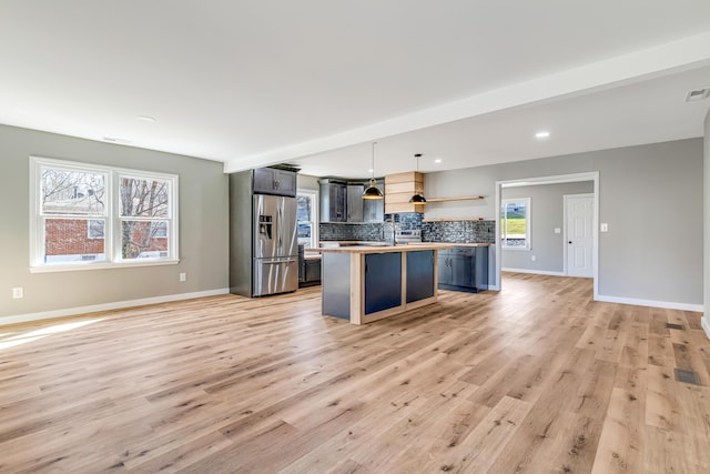 kitchen with light wood-type flooring, open shelves, backsplash, open floor plan, and stainless steel fridge with ice dispenser