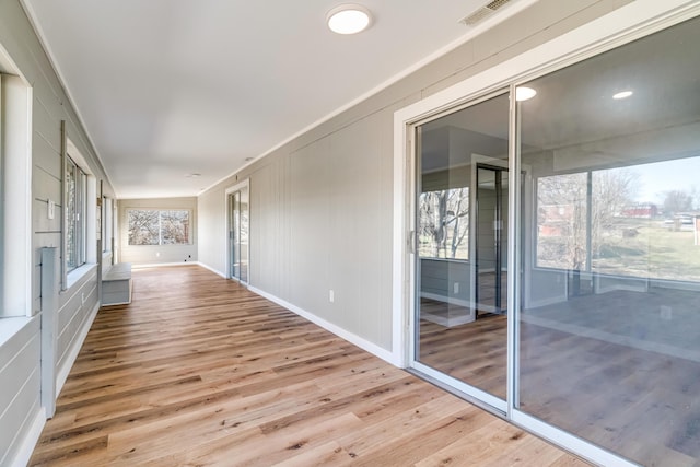 unfurnished sunroom featuring visible vents