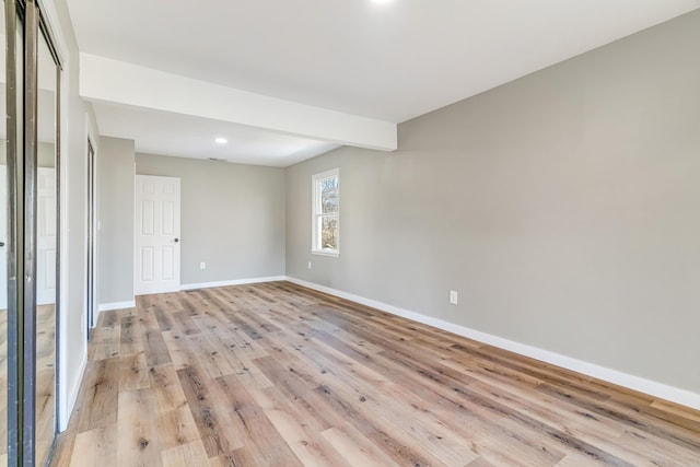 unfurnished room featuring light wood-type flooring and baseboards