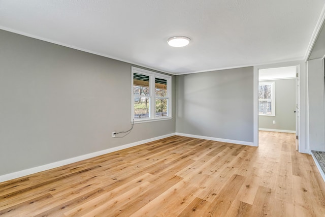 unfurnished room with baseboards, plenty of natural light, and light wood finished floors