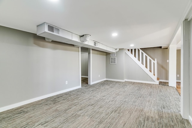 finished basement featuring stairway, recessed lighting, visible vents, and baseboards