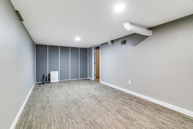 finished below grade area featuring recessed lighting, visible vents, carpet flooring, and baseboards