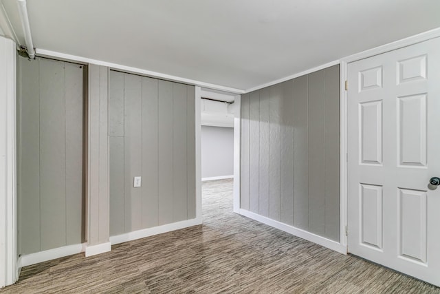 unfurnished bedroom with baseboards and wood finished floors