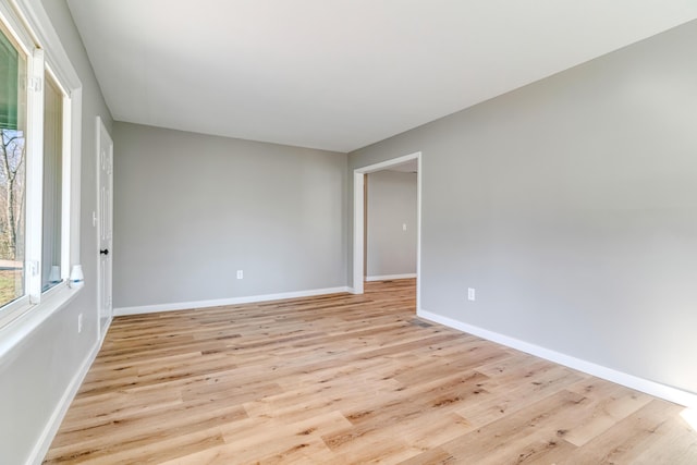 unfurnished room featuring light wood-style flooring and baseboards