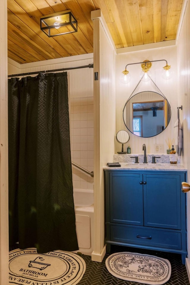 full bathroom featuring shower / bathtub combination with curtain, wooden walls, wood ceiling, and vanity