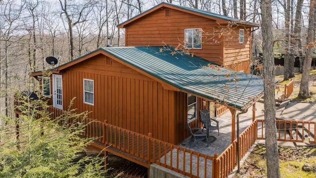 view of side of property with metal roof and a standing seam roof