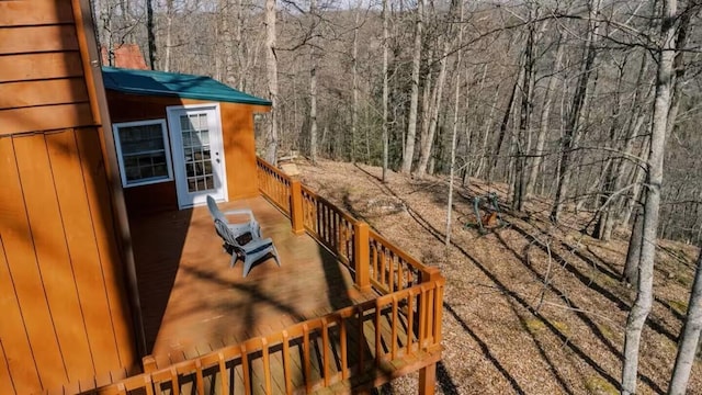 wooden deck featuring a forest view