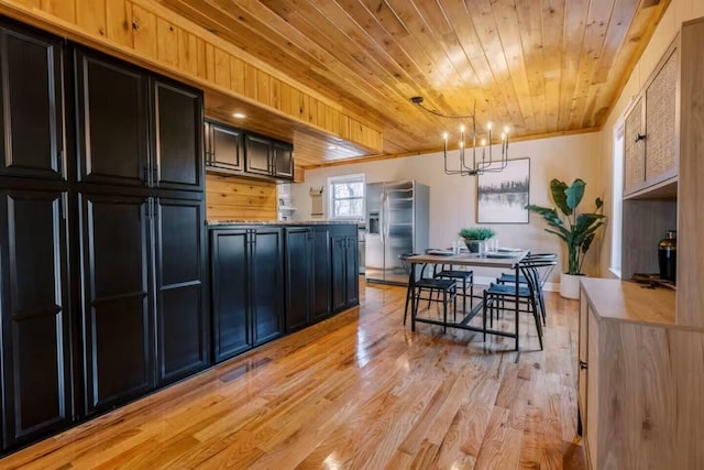 kitchen featuring ornamental molding, wood ceiling, light wood-style floors, and stainless steel fridge with ice dispenser