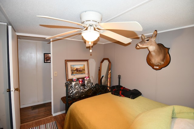 bedroom with a textured ceiling and wood finished floors