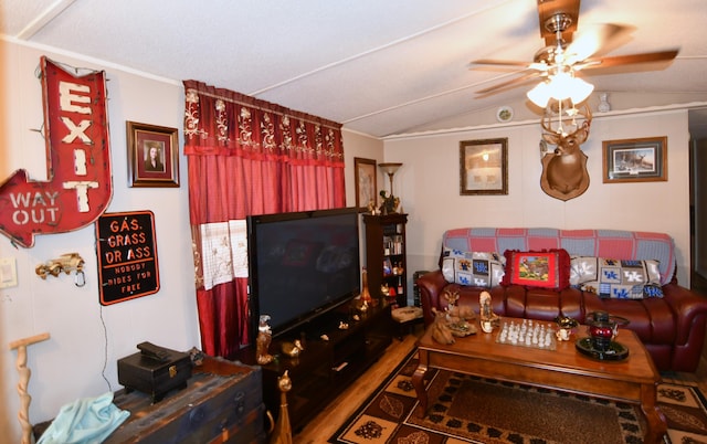 living area featuring lofted ceiling, wood finished floors, and ceiling fan