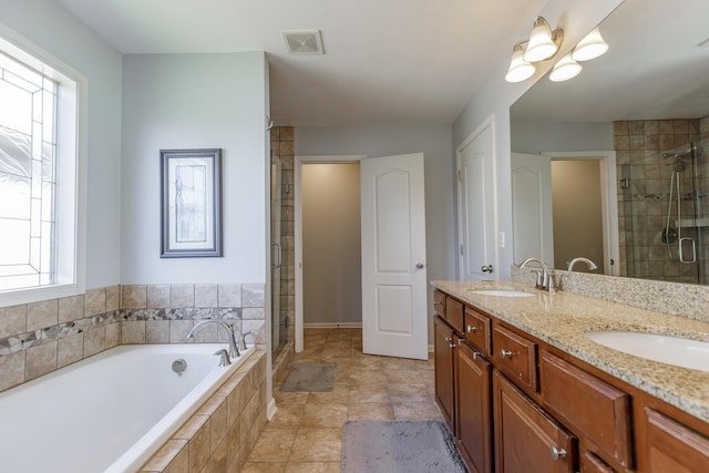 full bath featuring a garden tub, a stall shower, visible vents, and a sink