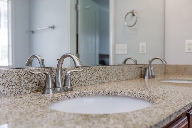 bathroom featuring double vanity and a sink