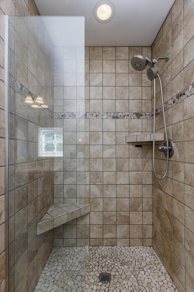 full bath featuring tiled shower