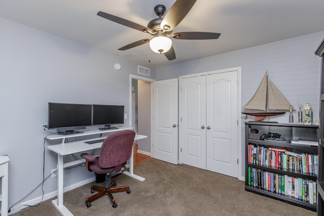 home office featuring visible vents, carpet flooring, baseboards, and ceiling fan