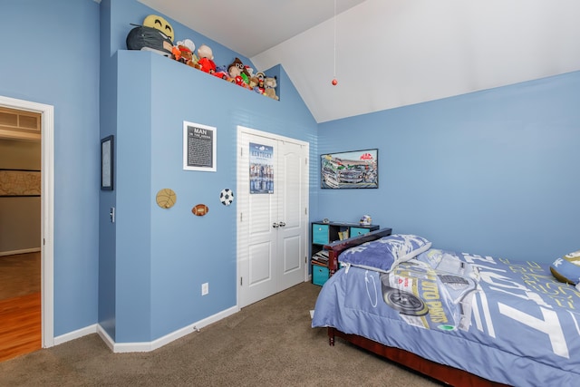 bedroom featuring visible vents, a closet, carpet floors, baseboards, and vaulted ceiling