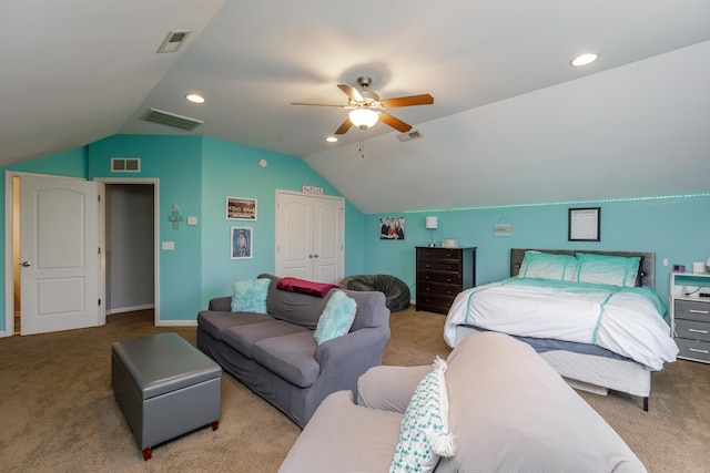 bedroom with visible vents, carpet floors, and vaulted ceiling