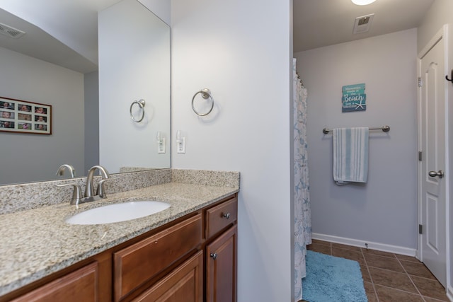 bathroom featuring tile patterned flooring, visible vents, vanity, and baseboards