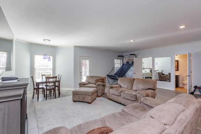 living room with recessed lighting, baseboards, and ornamental molding