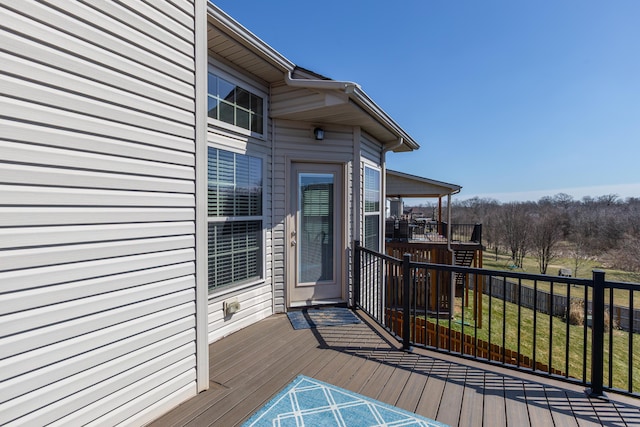 wooden deck featuring a yard