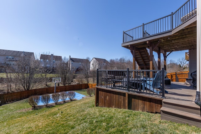 view of yard with a deck, stairway, and a fenced backyard